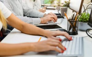 Cropped of Professionals Working on Laptops at Bright Modern Office