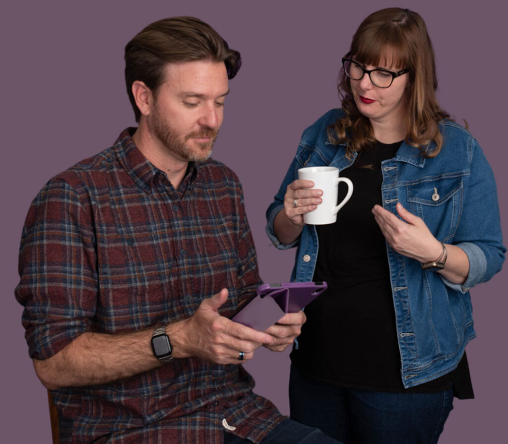 Two coworkers chatting and using tablet during break