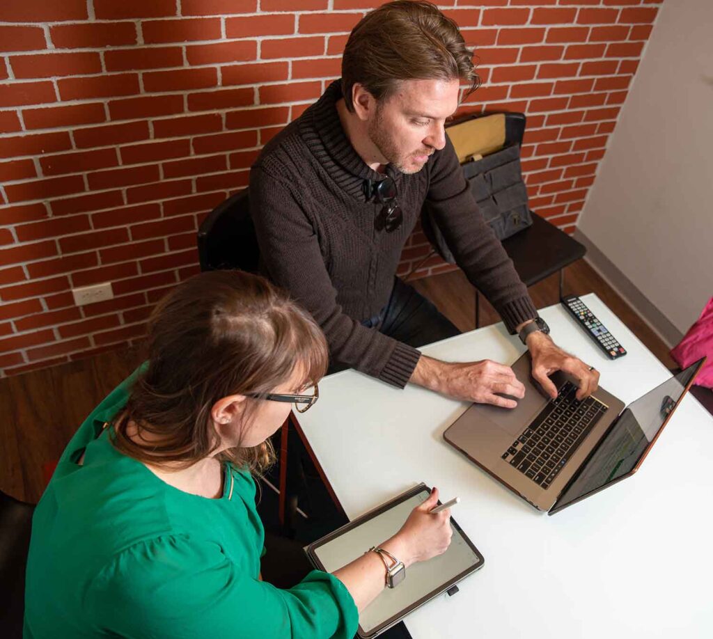 Man and woman working together on laptop