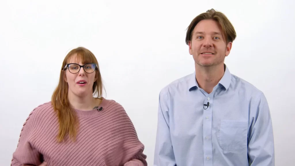 Two professionals standing against a white background